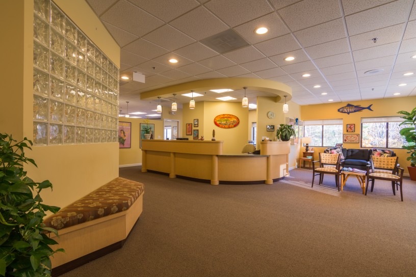 A reception area with a bench and a desk.